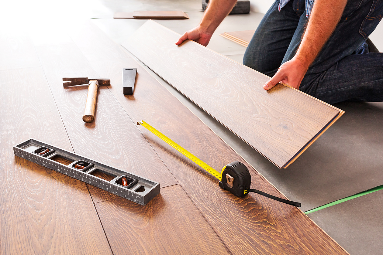 Man installing new laminated wooden floor
